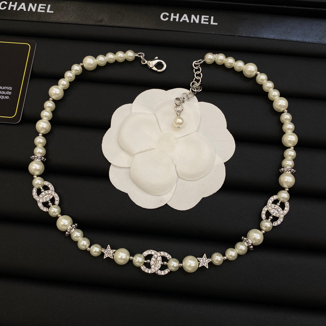 Long Faux Pearl Strand Necklace with Crystal Interlocking Loop & Star Charms