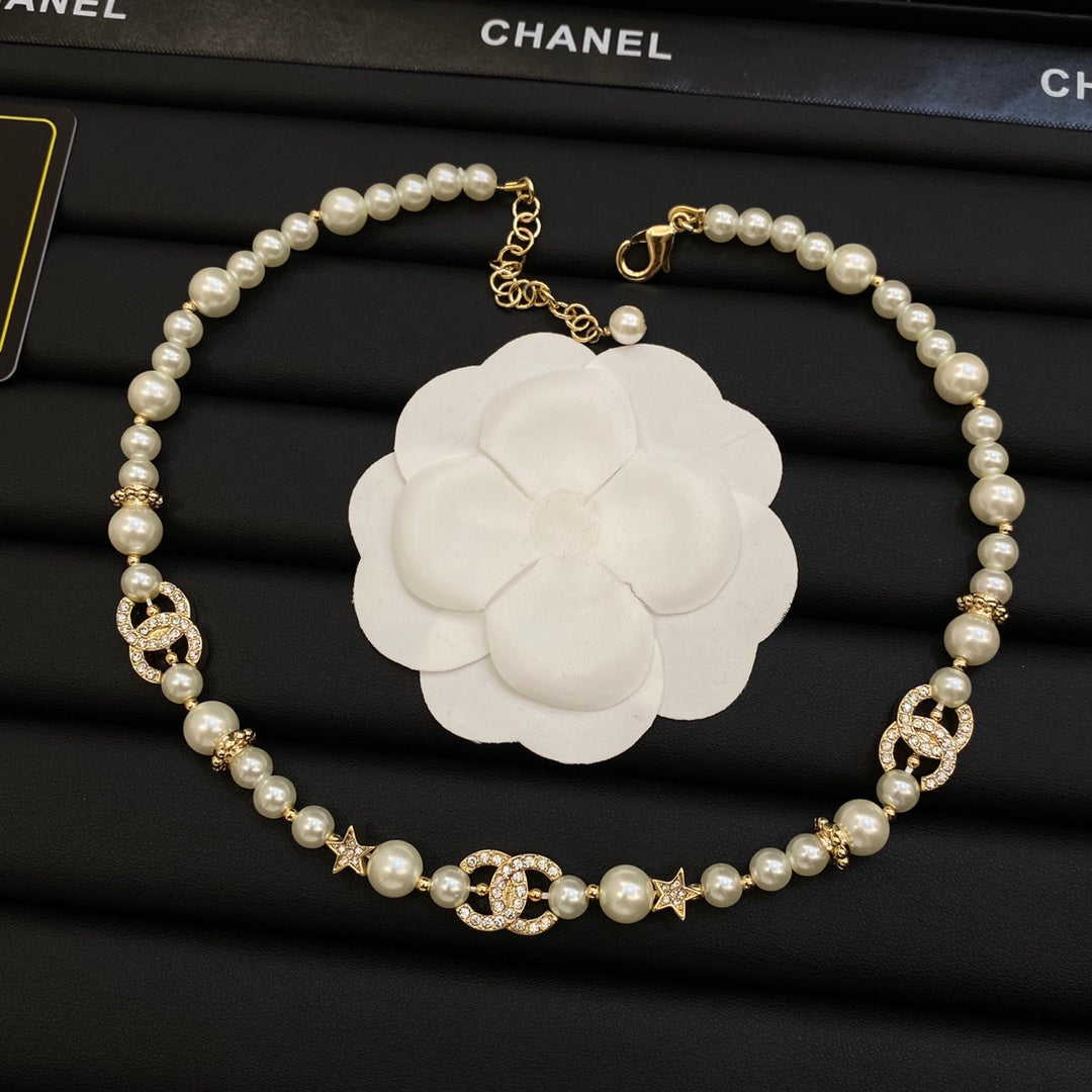 Long Faux Pearl Strand Necklace with Crystal Interlocking Loop & Star Charms