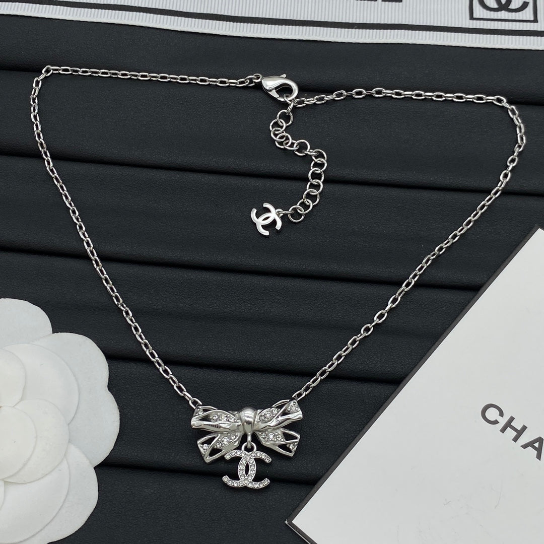 Pavé Crystal Hollow Bow & CC Charm Pendant Necklace – Gold & Silver