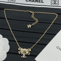 Pavé Crystal Hollow Bow & CC Charm Pendant Necklace – Gold & Silver